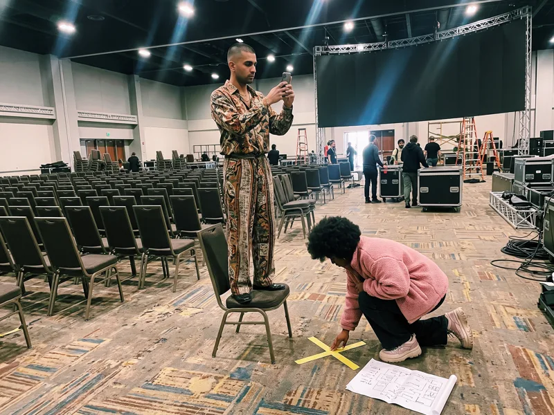 The team marks the viewpoint with tape in an empty conference hall